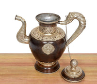 Dark brown brass teapot with open top rim, embossed medallion front, and chain