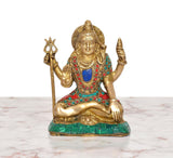 Lord Shiva brass statue seated cross-legged, holding trident, ornate multicolor clothing