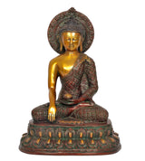 Golden Buddha idol seated in meditation, halo behind head, ornate robe details