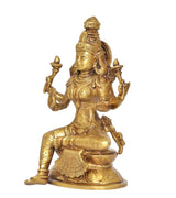 Brass Lakshmi statue in side view, seated on lotus base with raised hands