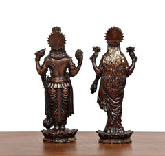 Back view of brass Lakshmi and Vishnu idols with textured garments and crown