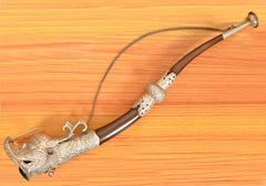 Metal dragon trumpet horn wall hanging with silver bell tip, brown curved tube and chain