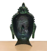 Back of brass Buddha head wall hanging, dark textured crown and green patina finish