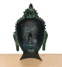 Back of brass Buddha head wall hanging, dark textured crown and green patina finish