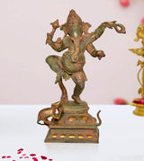 Dancing Ganesha brass statue with raised trunk, four arms, and ornate base details