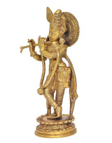 Brass Krishna idol statue side view, flute in hand, textured ornaments on pedestal