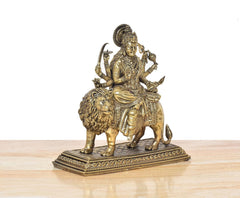Brass Durga Maa statue on lion, angled view, intricate headpiece and weapon arms