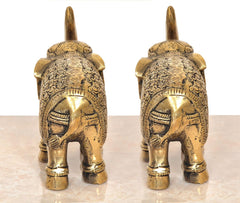 Brass elephant figurines, rear view of 2 elephants with tail up and engraved trunk patterns