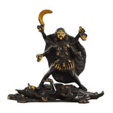 Brass Kali Maa idol: crescent ornament overhead, ornate black attire, seated on figures