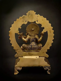 Brass Saraswati statue seated with back-facing halo disk on raised plinth