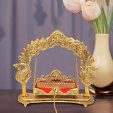 Gold metal Laddu Gopal swing cradle with arched frame, hanging chains, decorative stand