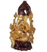Rear three-quarter view of brass Ganesha idol, gold ornaments and dark red lotus base