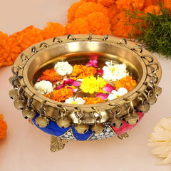 Brass urli bowl with bells, filled with multicolour flower petals