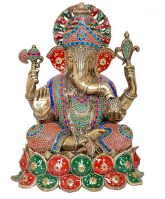 Lord Ganesha brass statue with multicolored crown, four arms, and decorative base