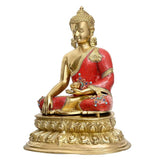 Brass Buddha statue in red robe, side view, hands in meditation on decorative base