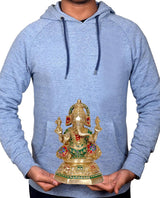 Brass Ganesha idol held in hands for scale, seated pose with painted ornaments