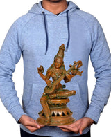 Person holding brass Maa Saraswati idol with veena; compact 12-inch home decor size
