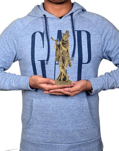 Small brass Lord Krishna idol figurine held in hands, playing flute design