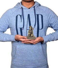 Small brass Hanuman sitting idol held in hands, showing crown and round base