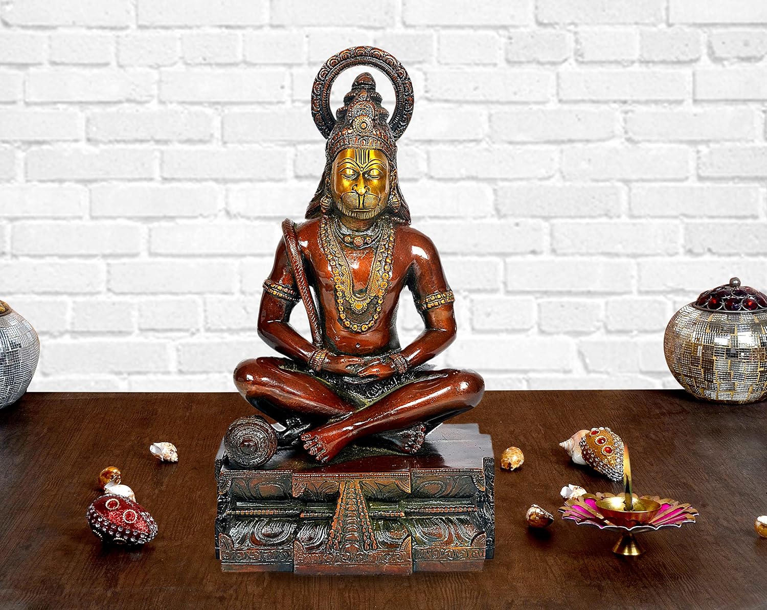 Bronze-toned Hanuman yoga pose idol statue, seated cross-legged on ornate base