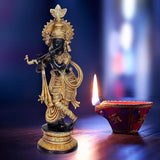 Lord Krishna flute-playing idol statue in dark bronze with gold detailing, round base