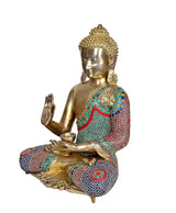 Brass Buddha idol in Abhaya mudra, side view, jeweled robe with red, teal, and blue pattern