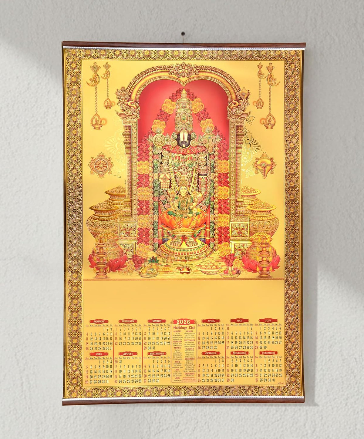 Gold foil 2026 wall calendar with Tirupati Balaji artwork, golden border and hanging