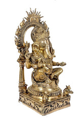 Gold brass Ganesha statue, three-quarter view showing raised arm and crown