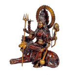 Brass Durga seated on lion holding trident, conch-like staff and discus, side view