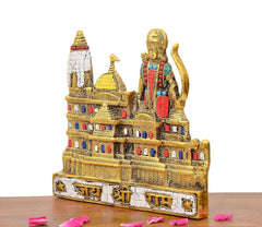 Side view of Ram Mandir metal model with white tower, golden walls, colored deity