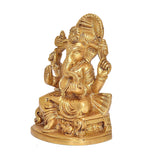Brass Ganesh idol statue, front three-quarter view, seated on pedestal