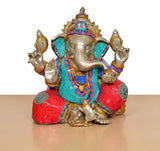 Brass Ganpati Bappa murti seated pose, red and teal mosaic-style garments, gold accents