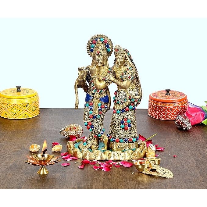Brass Radha Krishna idol with jeweled crowns, standing together on base.