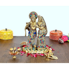 Brass Radha Krishna idol with jeweled crowns, standing together on base.