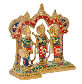 Brass ram darbar idol with raised hands, colorful outfits and detailed arch backdrop