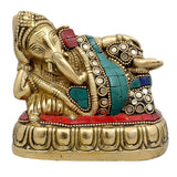 Brass resting Ganesha idol with jeweled blue and red accents, 4 in height