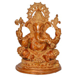 Brass Ganesha statue with detailed crown and four raised hands, seated on round base