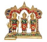 Brass ram darbar idol with ornate arch, three gold-toned figures in red, green and blue