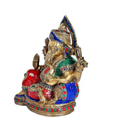 Brass Ganesha idol statue from side, multicolour robes and jewelry, trunk and crown