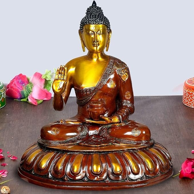 Brass seated Buddha idol, golden face and hands, brown robe, lotus base
