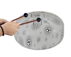 Happy steel drum with rubber mallet sticks resting on top, soccer pattern