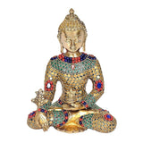 Brass Buddha idol seated cross-legged, gold face with blue, red, green stone inlay