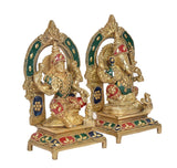 Lakshmi and Ganesha idol pair on pedestals, side view with green halo rings