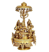 Brass seated deities under parasol on ornate rotating chowki stand