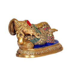 Brass Ganesha idol low-angle view, detailed hands and feet, red-green gemwork