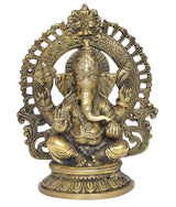 Brass seated Ganesha statue with elaborate arch halo, trunk forward, blessing hands
