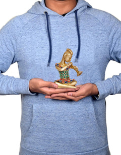 Brass musician showpiece held in hands, seated lady playing instrument with jeweled details