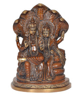 Front view brass Lakshmi and Vishnu sitting on Sheshnag, ornate detailing