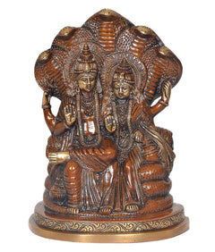 Front view brass Lakshmi and Vishnu sitting on Sheshnag, ornate detailing