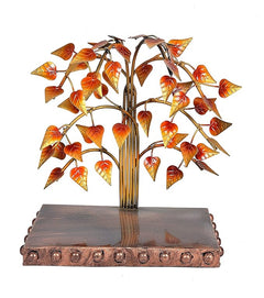 Iron bodhi tree sculpture with metal leaf branches and seated Buddha on pedestal